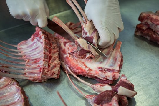 Butcher cutting meat