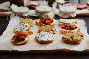 Mix of appetizers and toppings over crusty baguettes