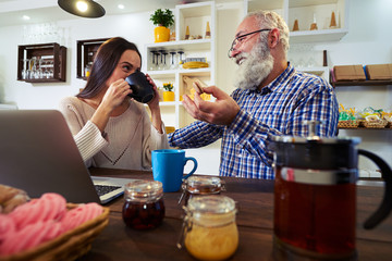 Pleasant conversation of senior man and woman eating macaroons a