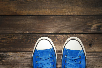 Blue Sneakers On Wooden Floor