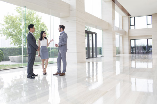 Business people talking in the office lobby