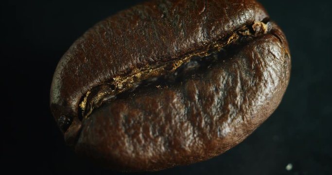 Macro shot of a roasted coffee bean. close up of high-quality arabic coffee with, produced in Brazil, Colombia and Venezuela.   