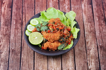Spicy sour fried chicken salad call Yum Kai Zap - Thai.