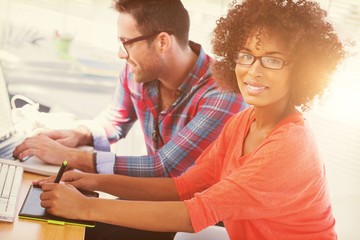 Graphic designer using a graphics tablet in her office