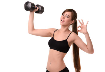 young smiling girl shows playful language and holds dumbbell,  gesture okay hand on white background fitness