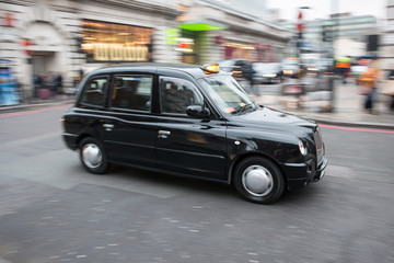 London black cab taxi in motion on the street