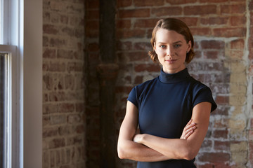 Head And Shoulders Portrait Of Young Businesswoman In Office