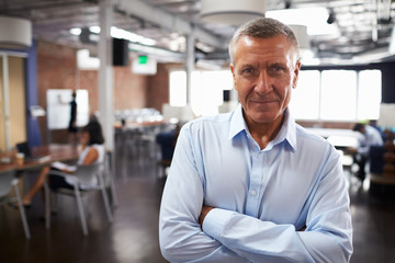 Obraz premium Portrait Of Mature Businessman In Modern Open Plan Office