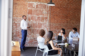 Businessman Standing To Address Boardroom Meeting