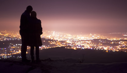 couple in love watching a city background
