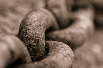 Black and white picture of a rusty metal chain, selective focus