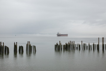Serene cargo ship waiting on the Columbia River in Astoria, Oregon.
