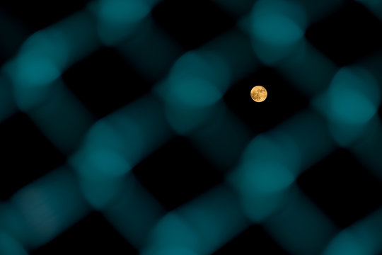 Moon through the fence