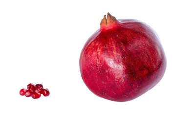 Pomegranate, whole and seeds isolated on white.