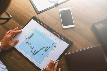 Business woman at workplace at wooden office table analyzes the