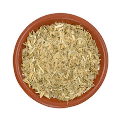 Bowl of oatstraw herb on a white background top view.