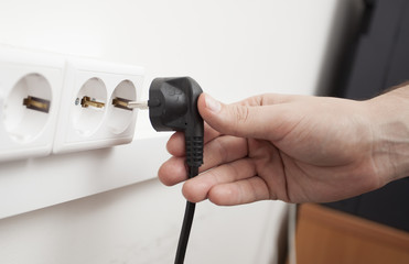 Fototapeta premium hand includes a wall socket