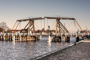 Fototapeta premium Germany, Greifswald, Wieck: Old wooden draw bridge, river Ryck and houses in the background. The bridge has been build in 1887.