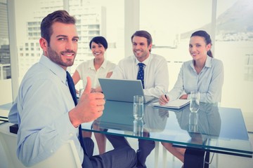 Executive gesturing thumbs up with recruiters during interview