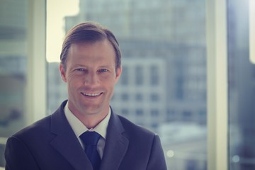 Naklejka premium Smiling businessman in his office