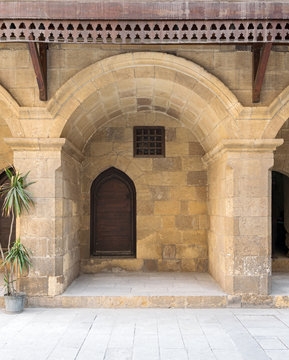 Wooden door and window covered with interleaved wooden grid at caravansary (Wikala) of Bazaraa, suited in Tombakshia street, Al Gamalia district, Medieval Cairo, Egypt