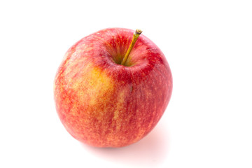 Shot from above of a ripe red juicy macintosh apple with a stem on a bright background