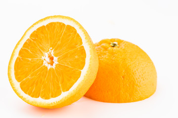 Closeup of an orange sliced in half face down and leaning