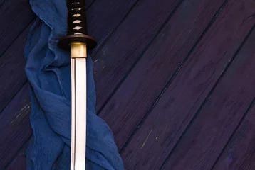 Fototapeten japan katana sword on the wood background with the blue shawl © bulgn