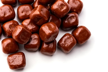 Closeup of square chocolates tumbling on a white background