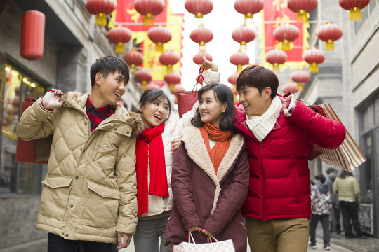 Happy young friends shopping for Chinese New Year