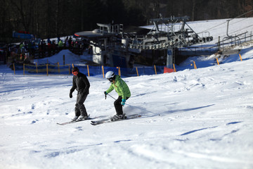 Kobieta i mężczyzna zjeżdżają na nartach z góry po śniegu. © Stanisław Błachowicz