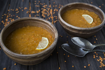 lentil soup with garlic and lemon in clay plates