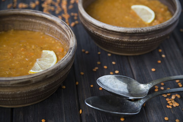 lentil soup with garlic and lemon in clay plates