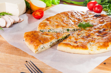 Selective Focus Traditional meat closed pie on the table. Composition of ingridients.