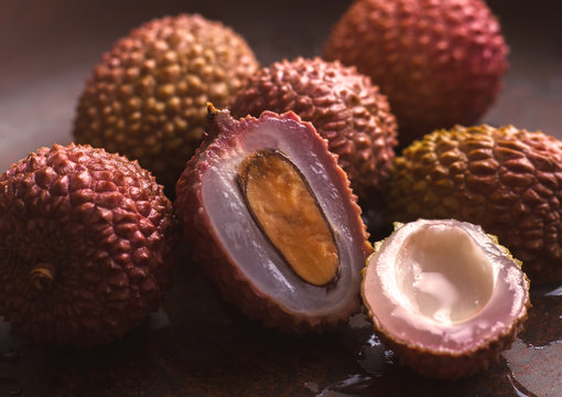 Lychee Fruit. One is cut with a bone. Close-up