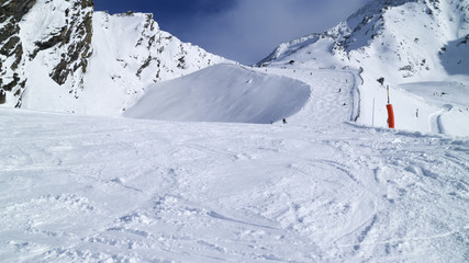 Snowy mogul slope on top of mountains, French Alps