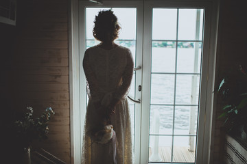 Girl with bouquette near the window
