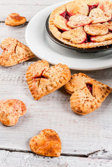 Idea for the celebration of Valentine's Day: big cherry pie and one-bite  cherry pies in the form of hearts, cup of coffee