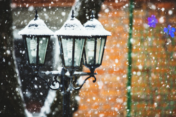 Street lamps in snowfall close up photo
