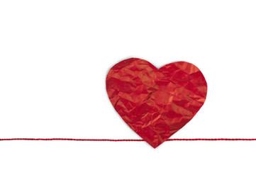 Red heart shape symbol made from red paper isolated on white background