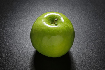 closeup of green apple on black sparkling background