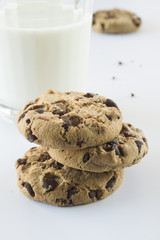 Biscuits with chocolate chips inside and a glass of milk.
