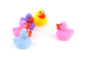 One rubber duckling speaking in front of a group of ducklings - concept of conversation or teaching