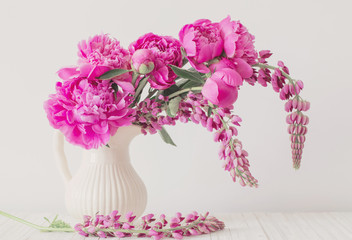 Peony flowers in vase on white background