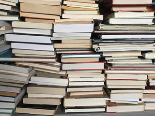 piles of old books background showing education and knowledge 