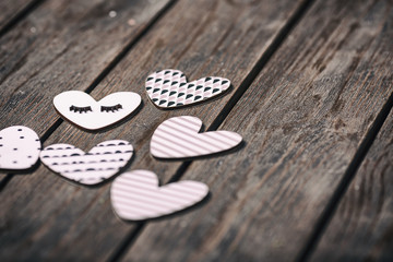 A wooden hearts on a wooden background. Valentines day background. Selective focus.