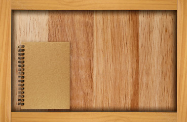 Wooden frame, wood background with natural materials. A brown cover blank notebook on wood background.