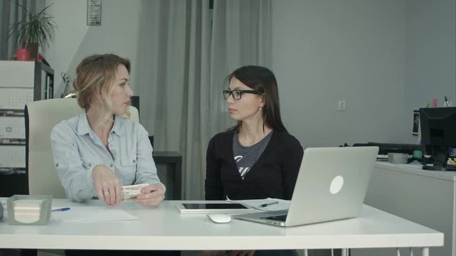 Senior manager giving salary in cash to new employee