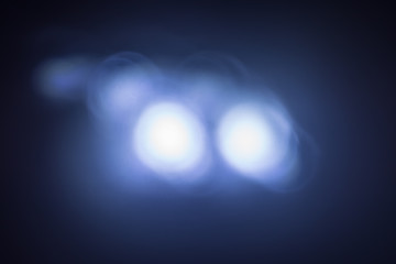 abstract, headlights on blue background