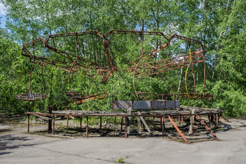 abandoned carousel at an amusement park in the center of the city of pripyat